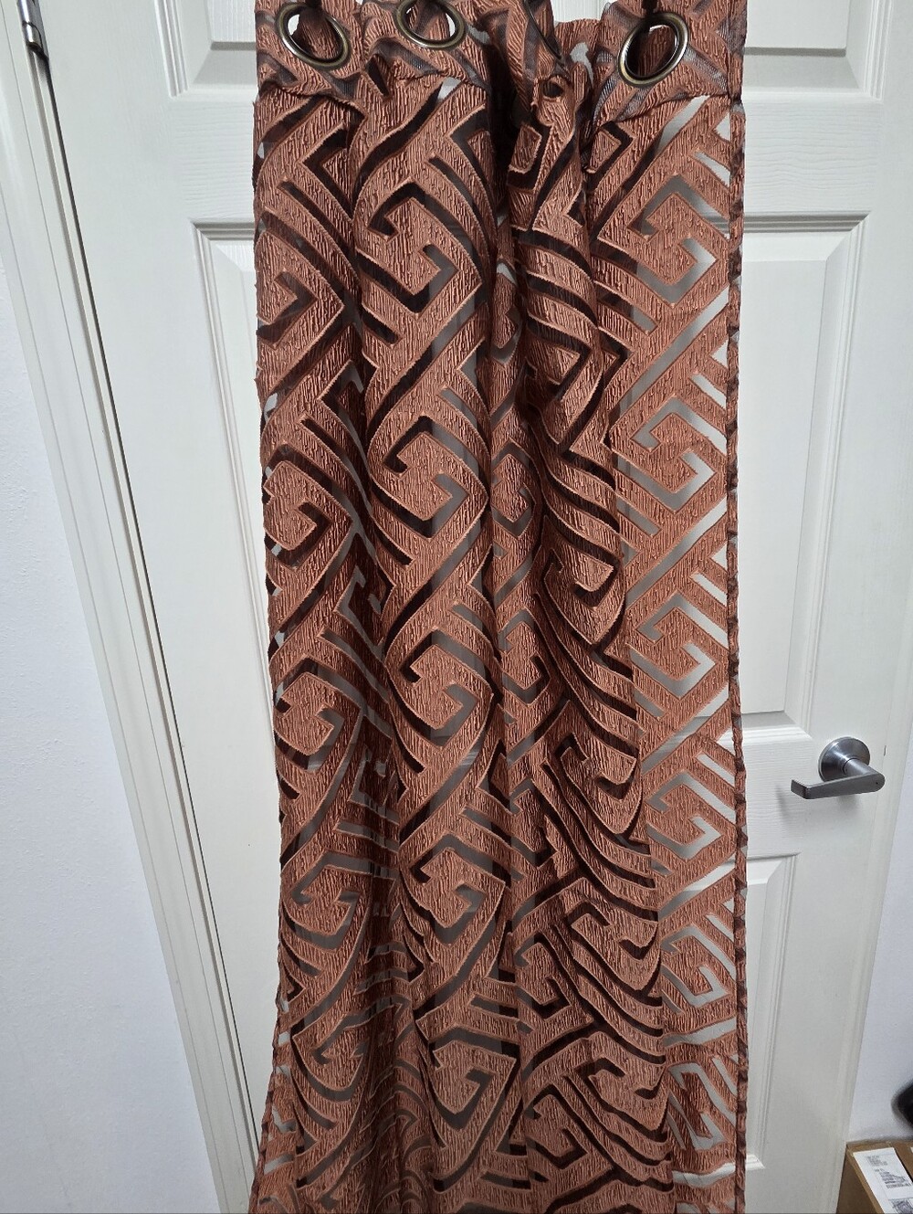 This terracotta-colored Linder Nairobi Rust Geometric Grommet Curtain Panels 2Q